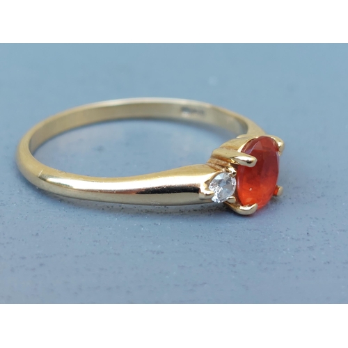 259 - A small Mexican fire opal & diamond three stone ring on 18ct gold shank.  Finger size Q.