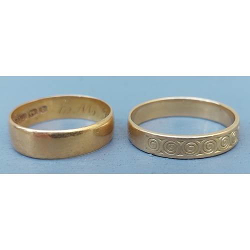 262 - A 22ct gold wedding ring with Birmingham marks and a French decorated French gold wedding ring. (2)