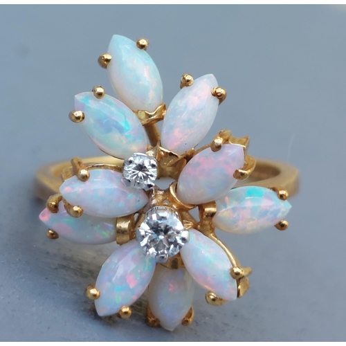 263 - A modern opal & diamond ring of eccentric cluster design in 18ct gold - London marks.  Finger size L... 