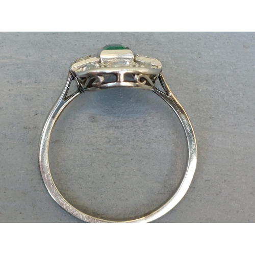 271 - An emerald & old cut diamond oval panel ring in white metal.  Finger size R/S.