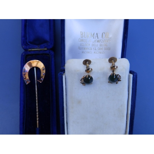 284 - A 15ct horseshoe stick pin and a pair of 14K earrings. (3)