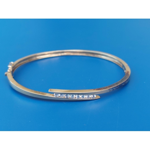 291 - A modern 9ct gold bangle set with eight small diamonds, 2.3