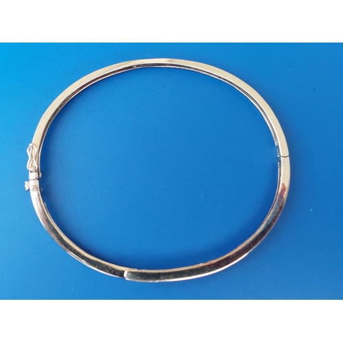 291 - A modern 9ct gold bangle set with eight small diamonds, 2.3