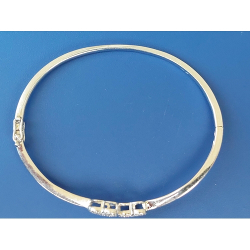 293 - A modern 18ct white gold bangle decorated with twin pave-set diamond hearts, maximum internal width ... 