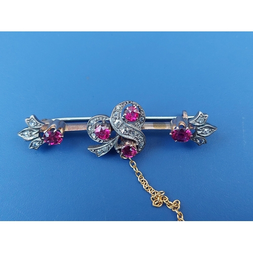 312 - An Edwardian ruby & rose cut diamond bar brooch, having shamrock design to centre and fleur de lys e... 