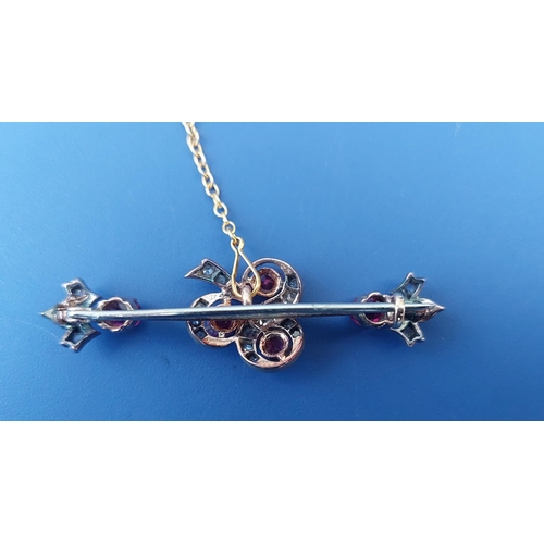 312 - An Edwardian ruby & rose cut diamond bar brooch, having shamrock design to centre and fleur de lys e... 