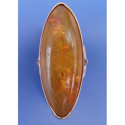 313 - A large amber set 9ct gold ring, of navette form, Sheffield marks, the amber 45mm across.  Finger si... 