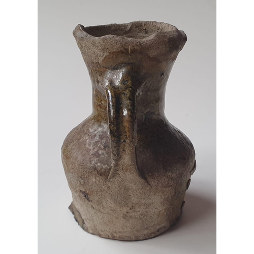 33 - A Medieval glazed pottery jug, with written note stating it was discovered during the building of No... 