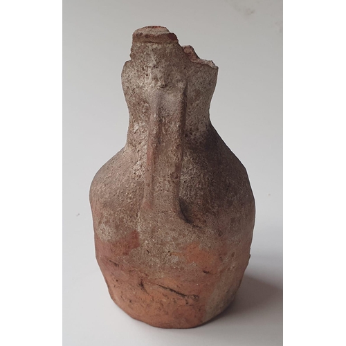 34 - A Medieval pottery jug, with note stating it was discovered during the building of the London & Sout... 