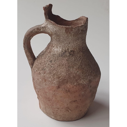 34 - A Medieval pottery jug, with note stating it was discovered during the building of the London & Sout... 