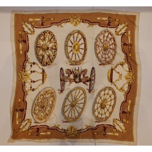 44 - A silk Hermes headscarf - Gun carriage with wheel devices in brown and gold on cream ground, designe... 