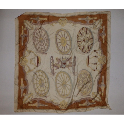 44 - A silk Hermes headscarf - Gun carriage with wheel devices in brown and gold on cream ground, designe... 