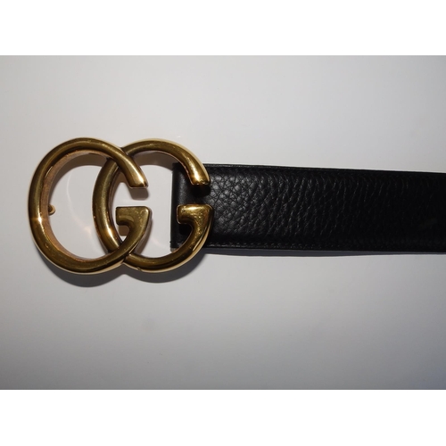 54 - A black leather Gucci belt with bold gilt metal GG buckle, 37.5