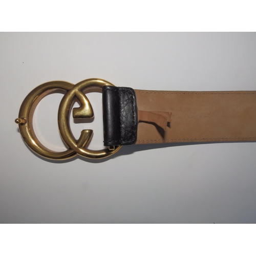 54 - A black leather Gucci belt with bold gilt metal GG buckle, 37.5