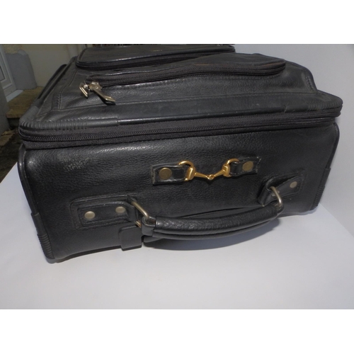 55 - A Gucci black leather travel case on wheels, 20