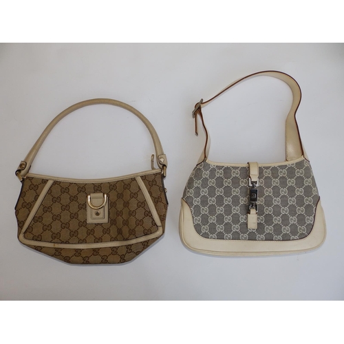 57 - Two cream canvas & leather Gucci handbags,  10.5