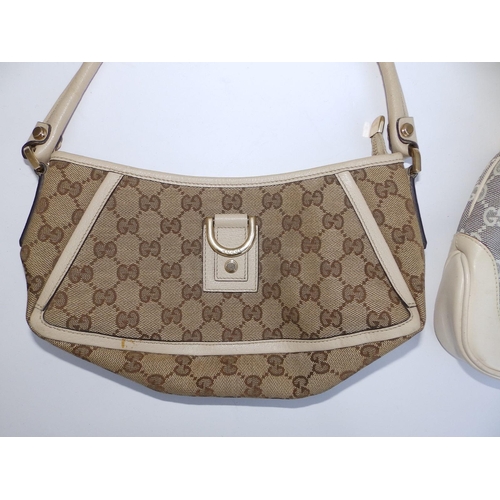 57 - Two cream canvas & leather Gucci handbags,  10.5