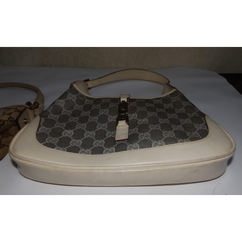 57 - Two cream canvas & leather Gucci handbags,  10.5