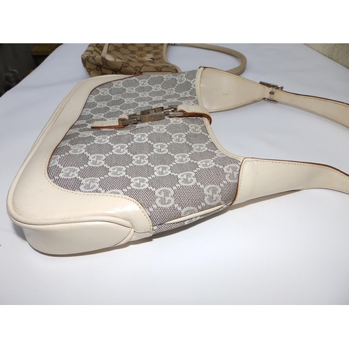 57 - Two cream canvas & leather Gucci handbags,  10.5