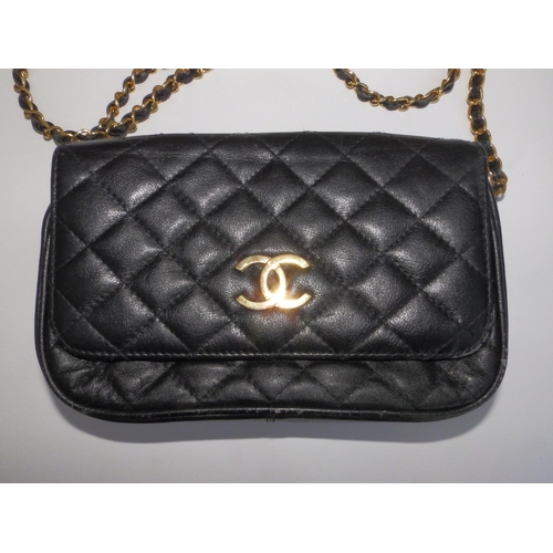 61 - A Chanel quilted black leather shoulder bag, bold interlaced C's to flap, on gilt metal & leather st... 