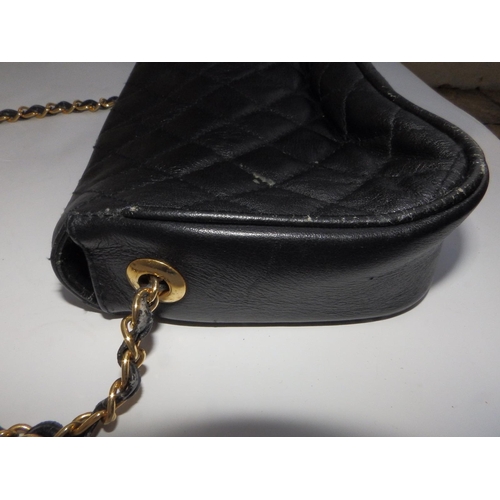 61 - A Chanel quilted black leather shoulder bag, bold interlaced C's to flap, on gilt metal & leather st... 