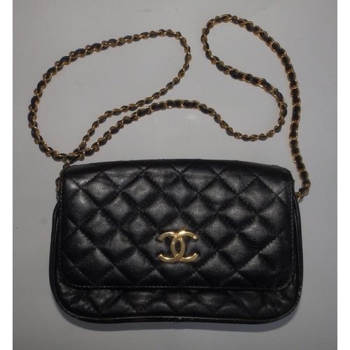 61 - A Chanel quilted black leather shoulder bag, bold interlaced C's to flap, on gilt metal & leather st... 