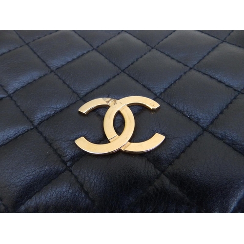 61 - A Chanel quilted black leather shoulder bag, bold interlaced C's to flap, on gilt metal & leather st... 