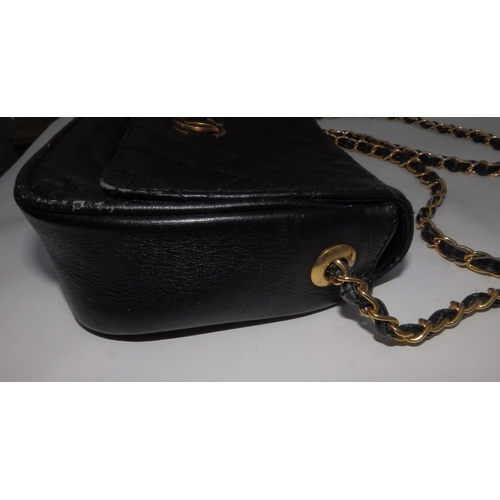 61 - A Chanel quilted black leather shoulder bag, bold interlaced C's to flap, on gilt metal & leather st... 