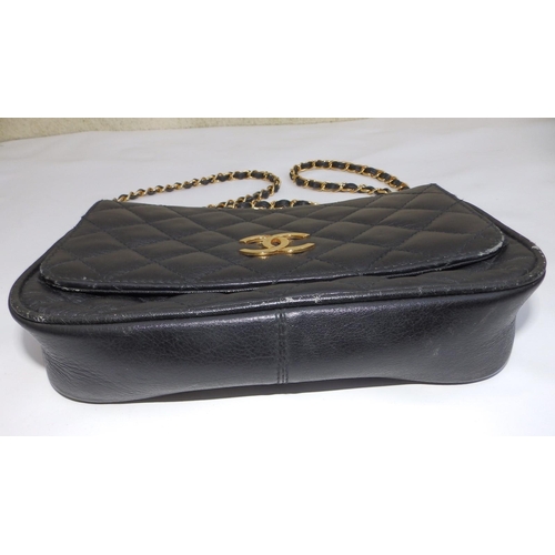 61 - A Chanel quilted black leather shoulder bag, bold interlaced C's to flap, on gilt metal & leather st... 