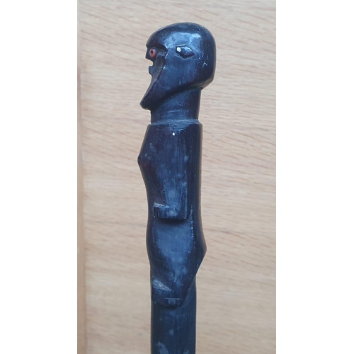 65 - An Afican carved wooden staff, probably Zulu, the figure with inset glass bead eyes, entwined double... 