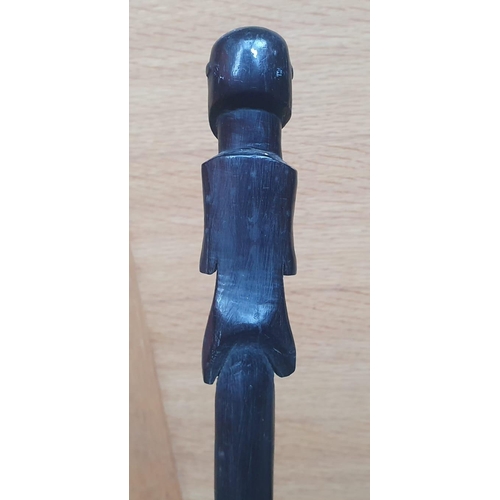 65 - An Afican carved wooden staff, probably Zulu, the figure with inset glass bead eyes, entwined double... 