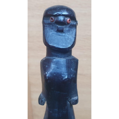 65 - An Afican carved wooden staff, probably Zulu, the figure with inset glass bead eyes, entwined double... 