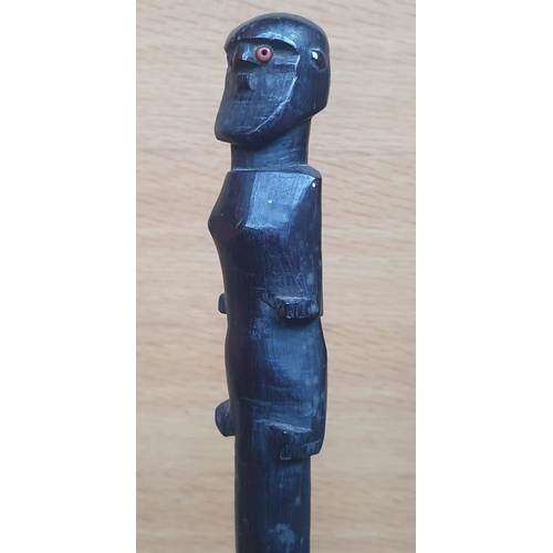 65 - An Afican carved wooden staff, probably Zulu, the figure with inset glass bead eyes, entwined double... 