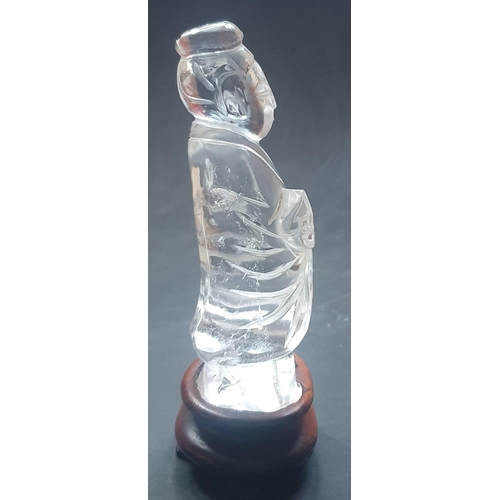 66 - A Chinese rock crystal figure on wooden stand, 5