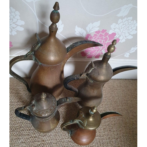 77 - Four Eastern Dallah coffee pots, the tallest 19