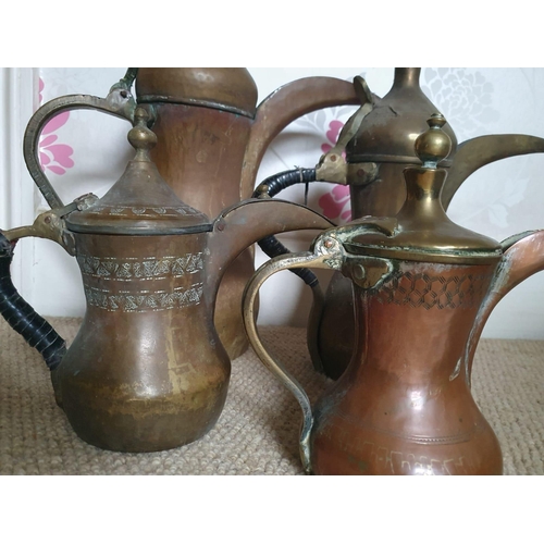 77 - Four Eastern Dallah coffee pots, the tallest 19