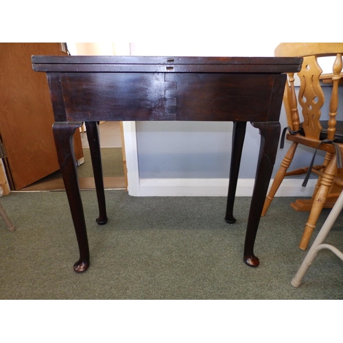 80 - A small Georgian folding mahogany tea table, with frieze drawer, round section legs to pad feet, Wid... 