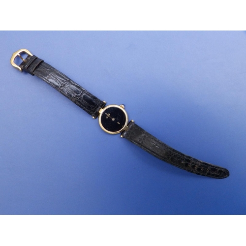 127 - A ladies gold plated Cartier Vermeil Quartz wrist watch with black dial devoid of hour markers, sapp... 