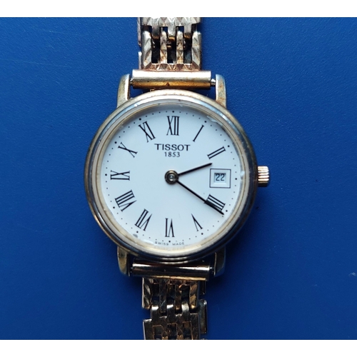 129 - A  ladies gold plated Tissot wrist watch having white dial with Roman numerals, date indicator, case... 