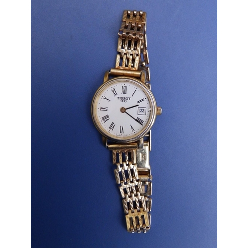 129 - A  ladies gold plated Tissot wrist watch having white dial with Roman numerals, date indicator, case... 