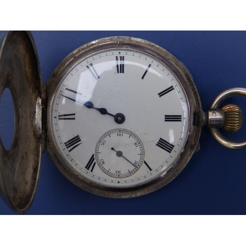 132 - A silver half hunter cased  presentation pocket watch,  50mm diameter and a (damaged)  trench style ... 