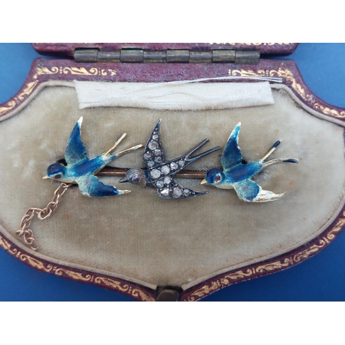 148 - A boxed bar brooch set with three swallows decorated in enamels & rose cut diamonds, 1.5