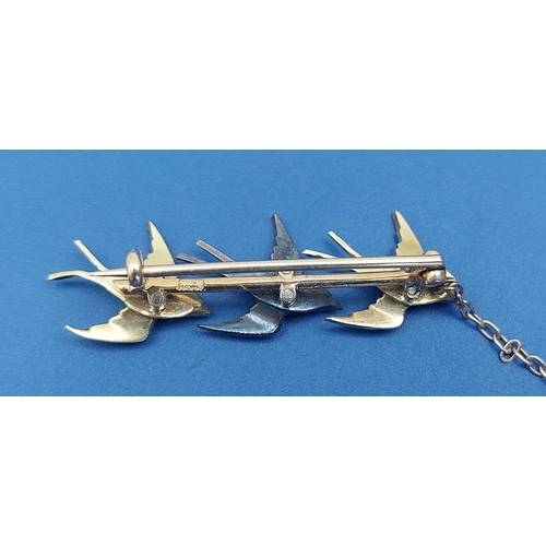 148 - A boxed bar brooch set with three swallows decorated in enamels & rose cut diamonds, 1.5