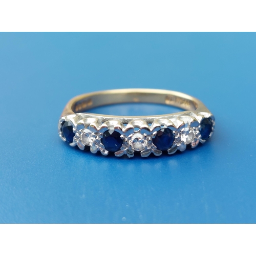 152 - A seven stone sapphire & diamond set 18ct gold ring.  Finger size M/N.