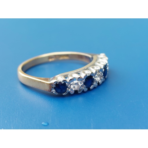 152 - A seven stone sapphire & diamond set 18ct gold ring.  Finger size M/N.