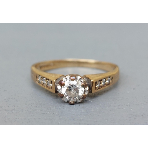 153 - A small illusion set diamond solitaire, small diamonds to shoulders on 9ct gold shank.  Finger size ... 