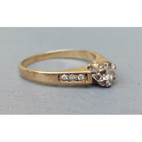 153 - A small illusion set diamond solitaire, small diamonds to shoulders on 9ct gold shank.  Finger size ... 