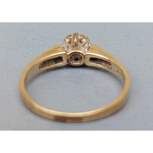 153 - A small illusion set diamond solitaire, small diamonds to shoulders on 9ct gold shank.  Finger size ... 