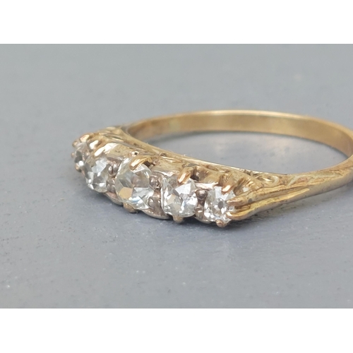 154 - A graduated five stone old cut diamond ring on yellow metal shank.  Finger size N.