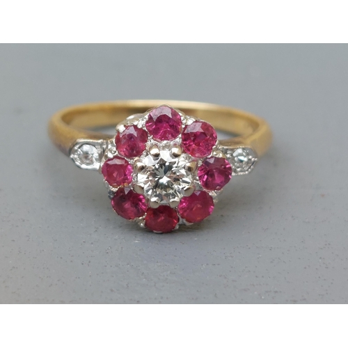 157 - A ruby & diamond cluster ring, small diamonds to shoulders, on '18ct' shank.  Finger size O.